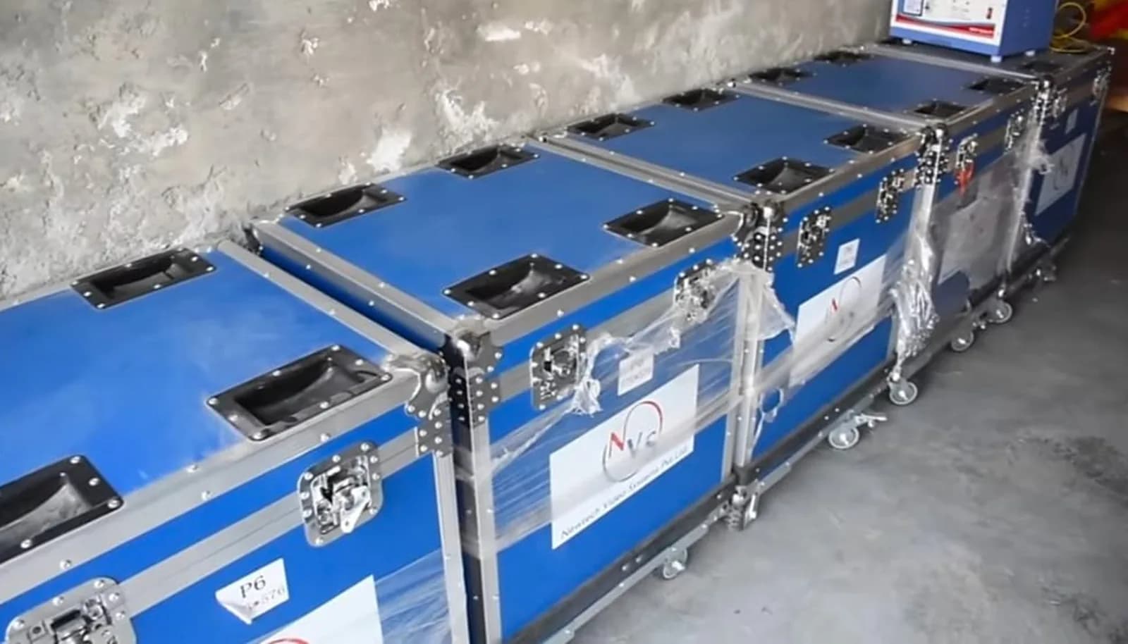 Row of blue flight cases used to transport LED cabinets